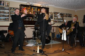 Lovely picture of Laurie on drums, with Mike Pointon on trombone and Colin Bray on curley soprano sax in Laurie Chescoe's Reunion Band at Farnborough Jazz Club, Kent, UK on 14th November 2014. Photo by Mike Witt.