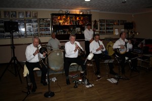 Golden Eagle Jazz Band at Farnborough Jazz Club, Kent, UK 12Dec2014. Leader, KEVIN SCOTT (tnr banjo&vocs), MIKE SCROXTON (trmp), ALAN CRESSWELL (cl), ROY STOKES (trmb&vocs), MIKE BROAD (dbass) and PETE JACKMAN (drms). Photo by Mike Witt.