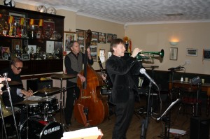 Phoenix Dixieland Jazz Band, 5December2014. (LtoR) Tony Blackburn (drms), Roger Curphey (d.bass) and Paul Higgs (trm).  Photo by Mike Witt.