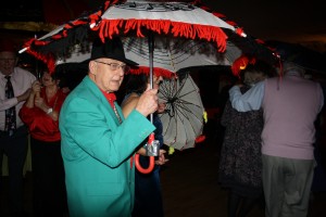 Steve (center) with Bob and June (left) take part in the brolly parade ('Bourbon Street Parade'). George Tidiman's All Stars at Farnborough Jazz Club 19Dec2014. Photo by Mike Witt.