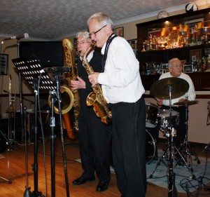 Bernie Holden (alto) & John Bayne (bass) (accompanying Hugh Crozier's feature) with Bob Dwyer's Bix & Pieces  at Farnborough Jazz Club, 30jan2015.  Photo by Mike Witt.