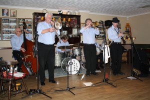 Barry Palser's Super Six at Farnborough Jazz Club, Kent (Barry, (trombone), Allan 'Lord Arsenal' Bradley (trumpet), Tim Huskisson (reeds), Tony Pitt (banjo), Harvey Western, (d.bass) & John Tyson (drums) 127Feb2015. Photo by Mike Witt.