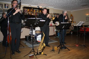 'Hot Lips' Jazz Band of Munich, Germany seen here at Farnborough Jazz Club, Kent on their 2015 UK Tour .6March. Leader MICHAEL “HOT LIPS” ETZEL (trump&vocs), BOB STRAUB (clarnt, alto & b.sax), HANNES EICKHORST (tromb), HEINI “THE TINY” BUCKENMAIER (drums), OTMAR “GEORGE” DICKER (d.bass) & WOLFGANG E. OTT (banjo). Photo by Mike Witt