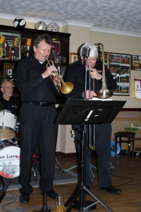 Leader MICHAEL “HOT LIPS” ETZEL (trump), HANNES EICKHORST (tromb) and HEINI “THE TINY” BUCKENMAIER (drums) from 'Hot Lips Jazz Band' of Munich, Germany seen here at Farnborough Jazz Club, Kent, UK 6th March 2015. Photo by Mike Witt.