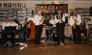 BOB DWYER'S BIX & PIECES at Farnborough Jazz Club on 1st May 2015. With BOB (tromb&voc) MAX EMMONS (trump), BERNIE HOLDEN (clar&sax), CHRIS NEWMAN (piano), JOHN BAYNE (d.bass &b.sax), NICK SINGER bnj&voc) and LAURIE CHESCOE (drms). Photo by Mike Witt.