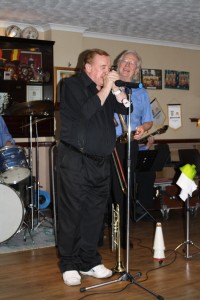 Brilliant Denny Islett plays his trumpet mouthpiece with George 'Kid' Tidiman's All Stars at Farnborough Jazz Club, Kent 17th April 2015. Photo by Mike Witt.