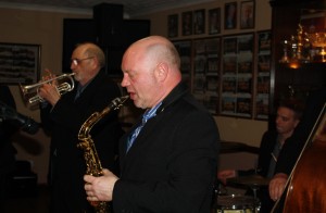 Matt Palmer (clarinet), Peter Brown (trumpet, cornet &valve trombone) & Julyan ‘Baby Jools' Aldridge (drums) with Millenium Eagle Jazz Band at Farnborough Jazz Club on 15th May 2015. Photo by Mike Witt.