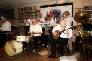Yerba Beuna Celebration JBYerba Buena Celebration Jazz Band seen here at Farnborough Jazz Club (Kent) on 26th June 2016. (LtoR) Hugh Crozier (piano), Goff Dubber (clarinet), Pete Lay (drums), Mike Barry (2nd trumpet &vocals), Dave Rance (1st trumpet &vocals). Nick Singe (banjo), Graham Wiseman (trombone) and John Arthy (tuba). Photo by Mike Witt.