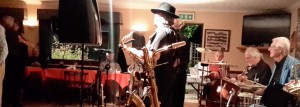 Harry Strutters Hot Seven at Farnborough Jazz Club, Keith's special birthday party. (LtoR) Tony Carter (reeds&vocs), Martin Litton (piano), Maurice Dennis (banjo), Graham Collicott (drums) & Allan Sokell (sousaphone). 7th August 2015. Photo by Jill Alexander.