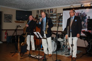 Mardi Gras Jazz Band at Farnborough Jazz Club on 21August2015. (LtoR) John Elmer on alto sax, with Leigh Henson singing and Rob Pierce on trombone Photo by Mike Witt. (LtoR) John Elmer on alto sax, with Leigh Henson singing and Rob Pierce on trombone.