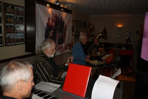 The 'engine' of Harry Strutters Hot Seven - Martin Litton ( piano), Leader Maurice Dennis (banjo), Graham Collicott (drums), Allan Sokell (sousaphone) for Keith's special birthday at Farnborough Jazz Club, 7th August 2015. Photo by Mike Witt.