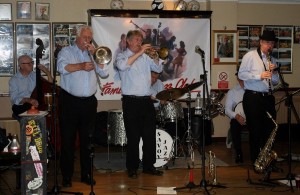 Barry Palser's Super Six at Farnborough Jazz Club, Kent (Barry, trombone, Allan 'Lord Arsenal' Bradley,trumpet, Tim Huskisson, reeds, Tony Pitt, banjo, Harvey Western, d.bass & John Tyson) 19June2015. Photo by Mike Witt.