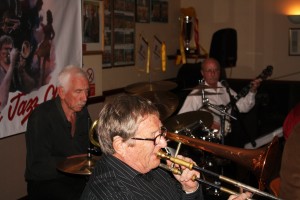 John Finch on trombone, Paul Norman on drums and Jim Heath on banjo play with Bill Phelan's Muscrat Ramblers here at Farnborough Jazz Club (Kent) on Friday, 2nd October 2015. Photo By Mike Witt.