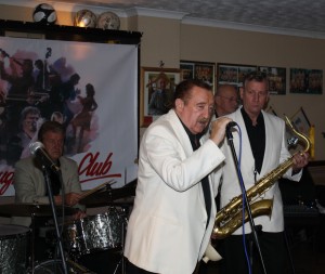 Denny Ilett sings, seen here with John Tyson (drums), Al Nichols (tenor sax) and Tony Pitt (banjo) with 'Tony Pitt's All Stars' at Farnborough Jazz Club (Kent) on 9th October 2015. Photo by Mike Witt.