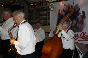 Bob Dwyer's Bix & Pieces at Farnboro JC's Xmas Party 18th December 2015. LroR Andy Woon (trumpet), Bernie Holden (sax), John Elmer (drums) & John Bayne (d.bass). Photo by Mike Witt.December 2015. LroR Andy Woon (trumpet), Bernie Holden (sax), John Elmer (drums) & John Bayne (d.bass). Photo by Mike Witt.