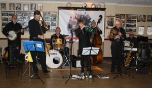 Phoenix Dixieland Jazz Band at Farnborough Jazz Club on 22nd Jjanuary 2016. ( LtoR) John Stuart (banjo), Bill Todd (trombone), Alan Clarke (drums), Paul Higgs (trumpet), Roger Curphey (d.bass), Charles Sherwood (reeds) & Dave Barnes (piano). Photo by Mike Witt.