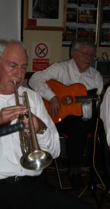 Band leader Mike Jackson on trumpet and Lynn Saunders on banjo playing here for Lord Napier Hotshots at Farnborough Jazz Club (Kent) on 26th February 2016. Photo by Mike Witt.