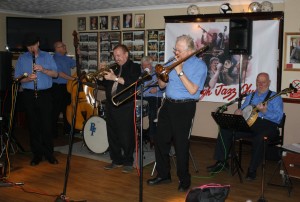 George 'Kid' Tidiman's All Stars at Farnborough Jazz Club on 1st April 2016. (LtoR) Tim Huskisson (clt), John Sirett (d.bass), Denny Ilett (trp), Bill Finch (drms), George 'Kid' Tidiman (trmb) & 'Southend Bob' Allbut (bnj). Photo by Mike Witt.