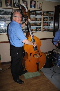 John Sirett plays double bass and enjoys the fun with George 'Kid' Tidiman's All Stars at Farnborough Jazz Club (Kent) on1st April 2016. Photo by Mike Witt.