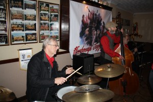 The 'Engine' of Mike Barry's Uptown Gang at Farnborough Jazz Club. (LtoR) Graham Collicotte - drums, Roger Curphey, double bass and John Stewart - banjo on 8th April 2016. Photo by Mike Witt.