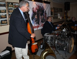 'Engine Boys' of Mardi Gras JazzBand playing at Farnborough Jazz Club (Kent) on 13th May 2016. (L2R) Marc Easener (bass), Paul Baker (drums) and John Stewart (guitar). Photo by Mike Witt.