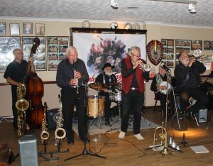 Dave Rance's Rockin' Chair Band at Farnborough Jazz Club (Kent) on Friday 10th June 2016. (LtoR) Mike Brewerton (d.bass), Derek Scofield (reeds)Henry Harrison (drums), Dave Rance (trumpet), Doug Parry (banjo/guitar) & Graham Wiseman (trombone). Photo by Mike Witt.