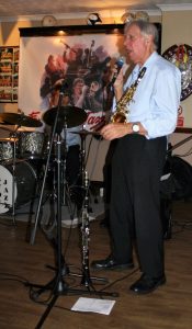 Goff Dubber (reed player) seen here singing, as one of 'Barry Palser's Super Six, here at the Farnborough Jazz Club (Kent) on 15th July 2016. Photo by Mike Witt.